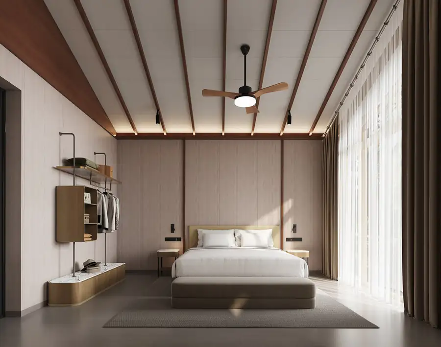 A grand bedroom at Doris Mataking Resort where the bed faces panoramic glass doors opening onto a private balcony with sea views