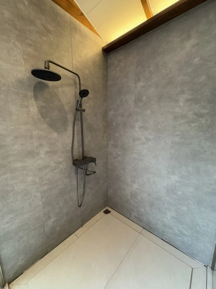 An elegant vanity area at Doris Mataking Resort with a modern wooden desk with double sinks and dual round mirrors