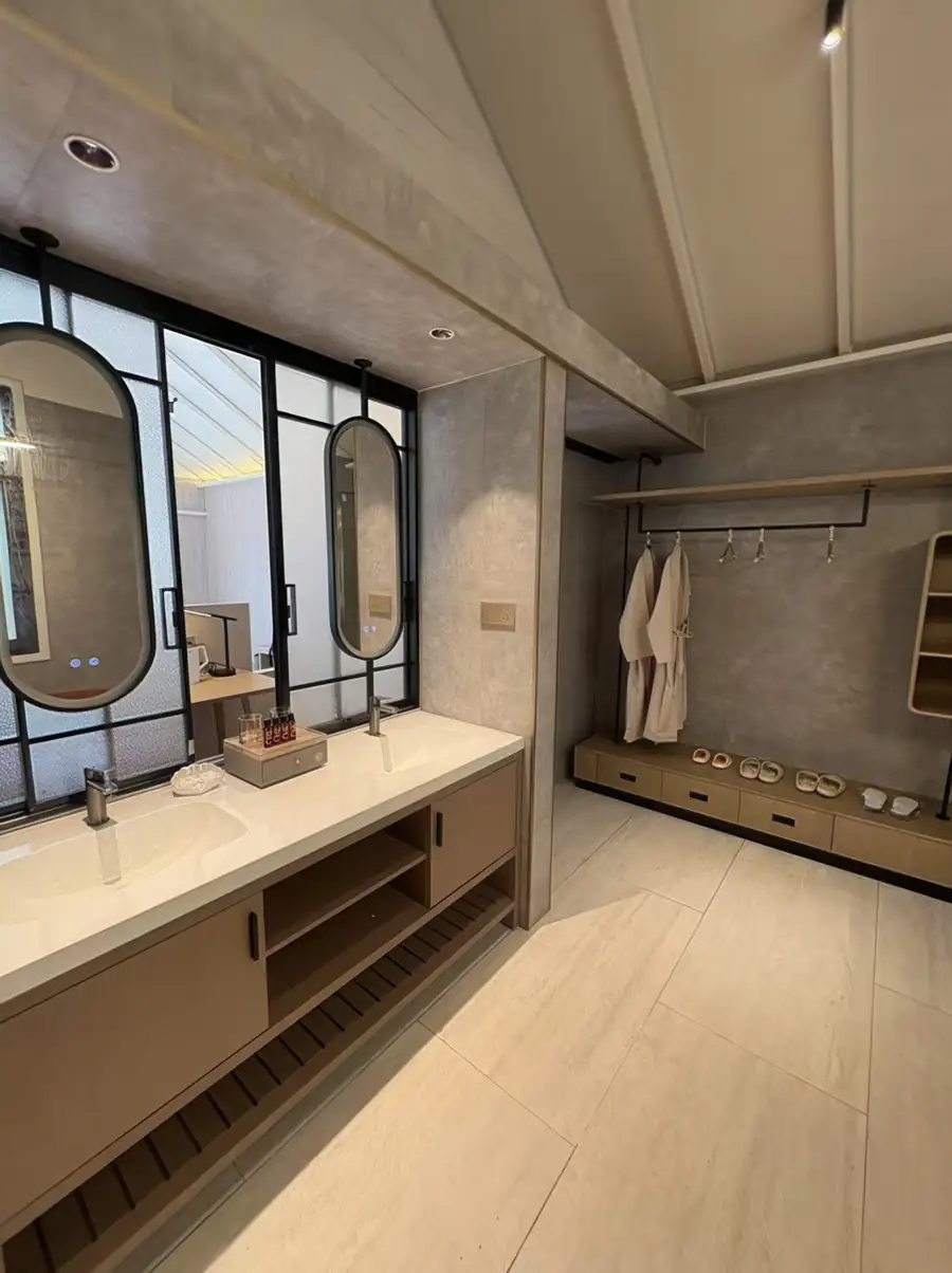 A modern double vanity with backlit mirrors and gleaming timber floors at Doris Mataking Resort