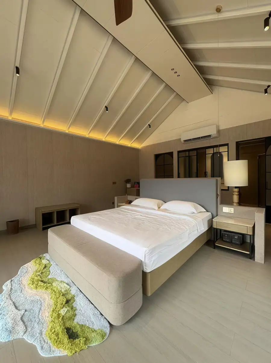 A superior bedroom at Doris Mataking Resort with a king bed, vaulted ceilings and warm wooden plank flooring