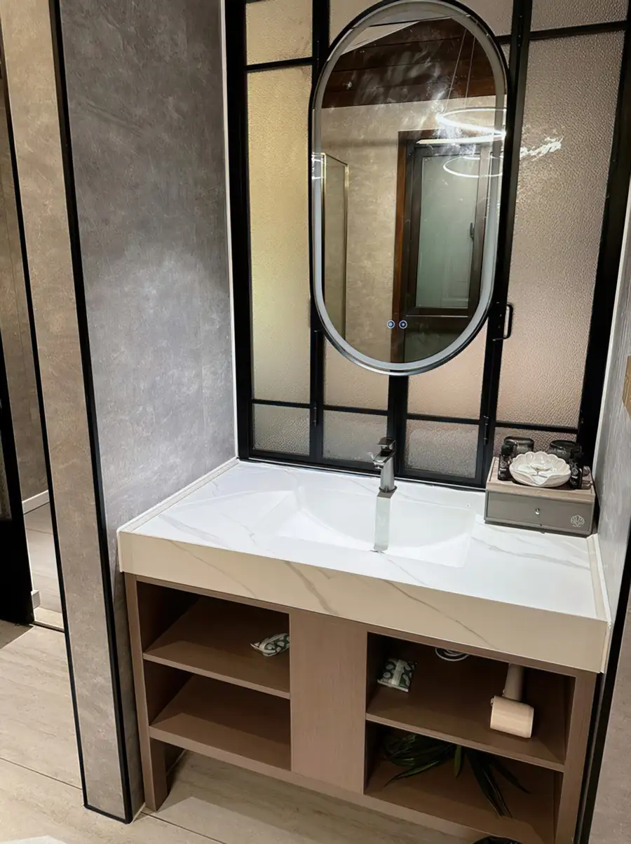 A premium bathroom at Doris Mataking Resort with a spacious double vanity, backlit round mirrors and a large glass shower stall